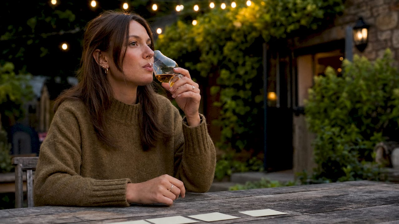 Close-up of hands tasting Scotch whisky