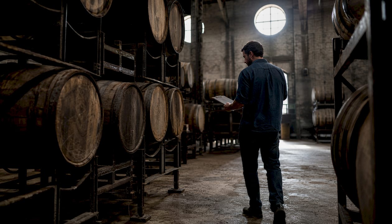 Whisky barrels aging in warehouse