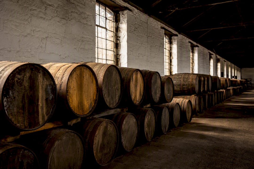 Rows of oak barrels in Speyside whisky warehouse