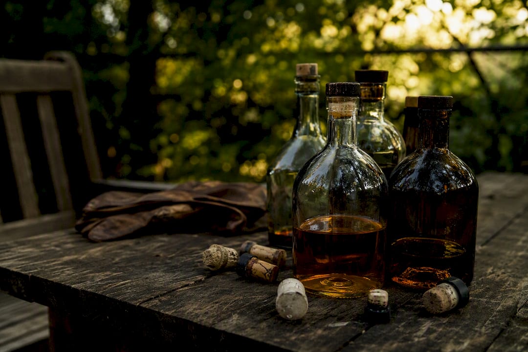 Close-up of vintage whisky bottles on wood