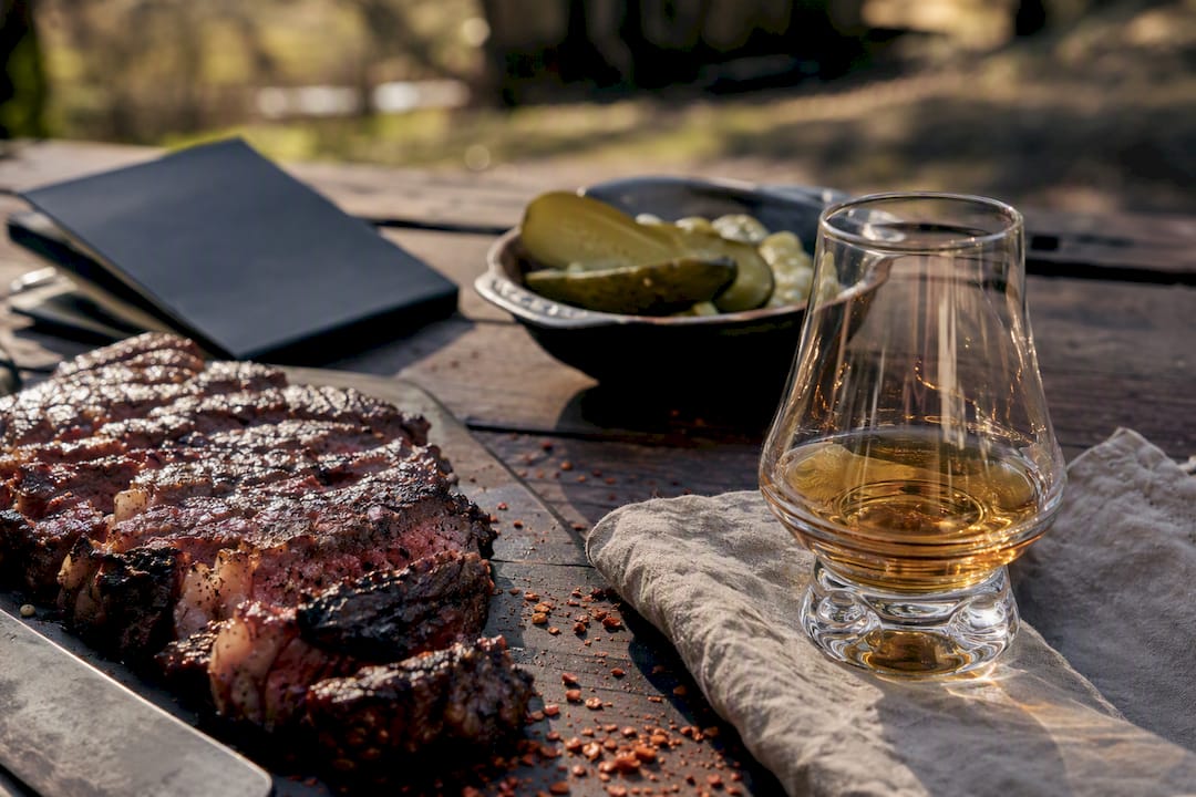 Whiskey glass with barbecue and steak food pairing