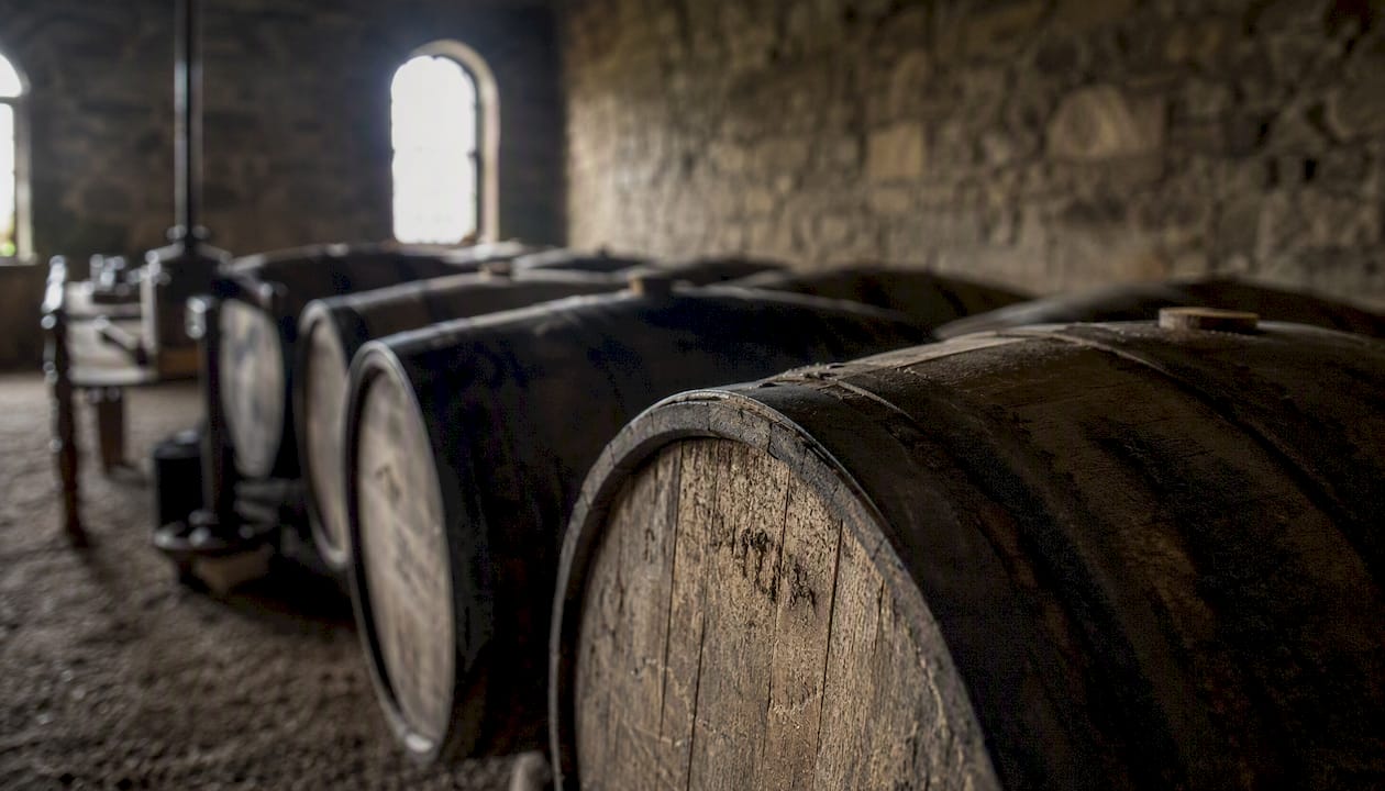 Historic whisky barrels in distillery warehouse