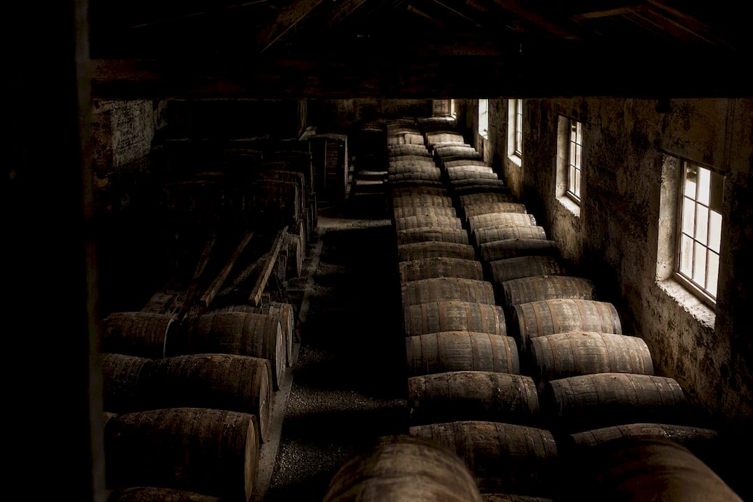 Whisky aging barrels in cellar