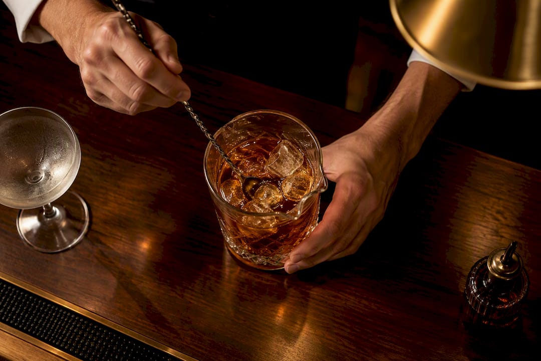 Rye cocktail being stirred with ice