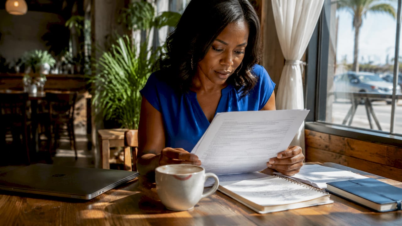 Buyer reviewing contingency offer documents at kitchen table
