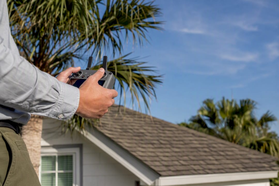 Inspector operating drone for roof inspection