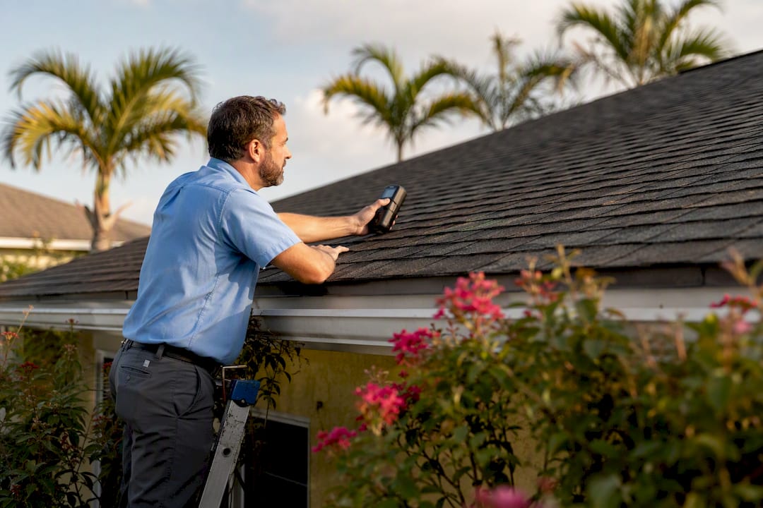 Home inspector examining Gulf Coast roof exterior