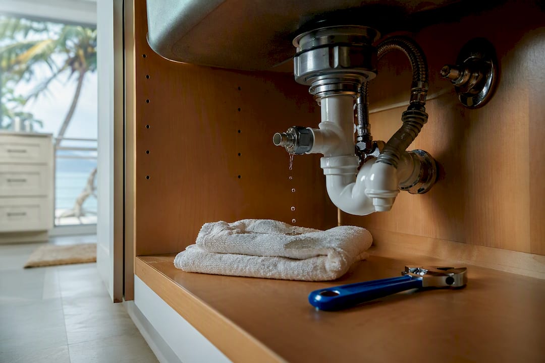Active leak beneath a kitchen sink cabinet
