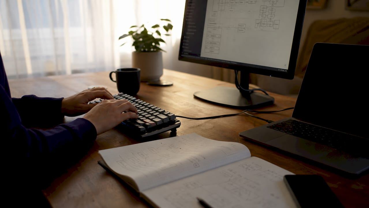 Developer hands preparing SEO redirects on desk