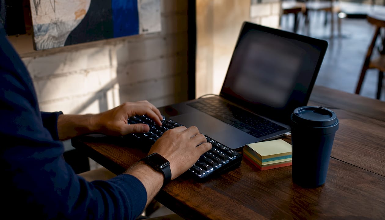 Hands typing on keyboard updating website securely