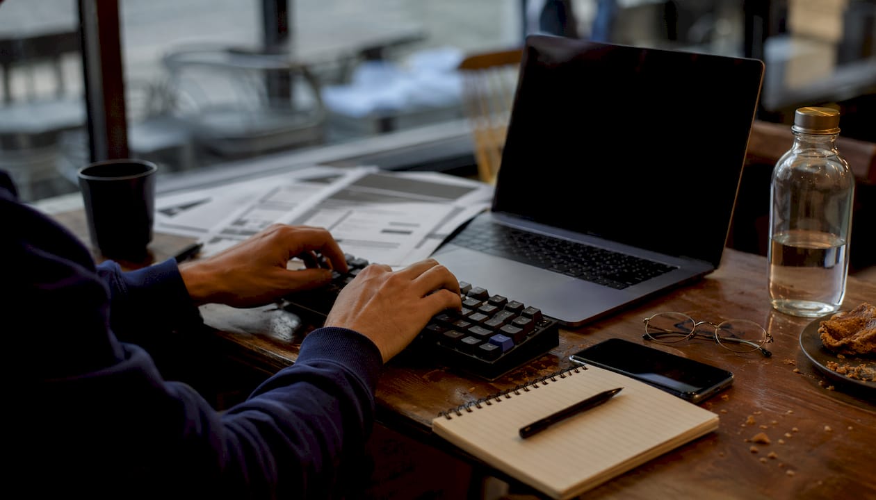 Hands typing amid WordPress plugin charts