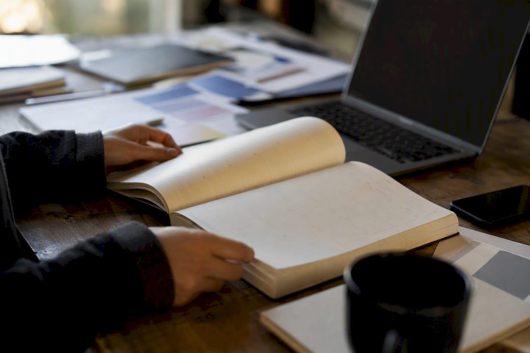 Hands turning calendar page at agency desk