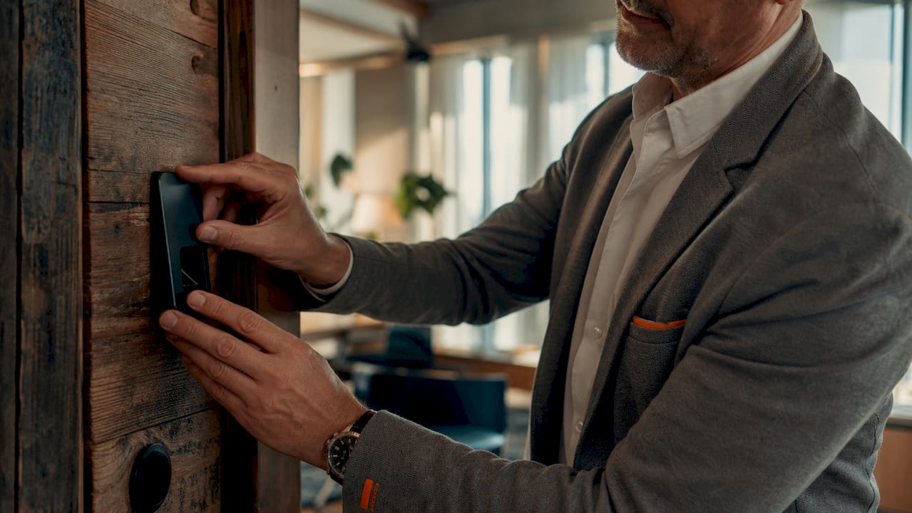 What Is Strong Authentication? Methods and Best Practices 2 Hands interacting with biometric fingerprint scanner