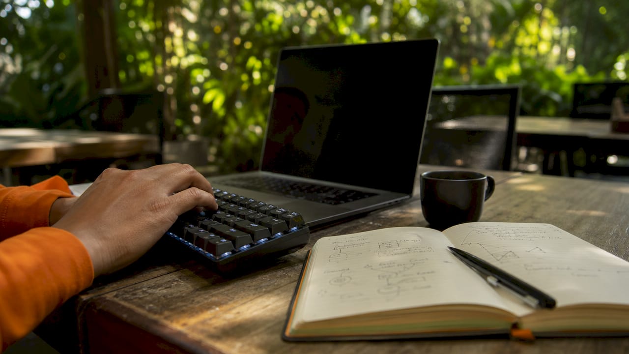 Close-up of hands typing on keyboard with security token