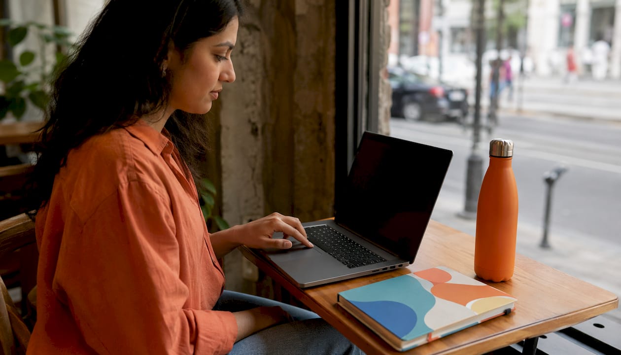 Examples of MFA: Practical Guide for Individuals & IT Teams 2 Woman authenticating laptop with fingerprint sensor