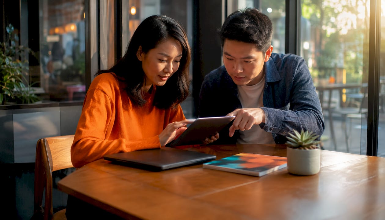 Two colleagues using tablet for authentication
