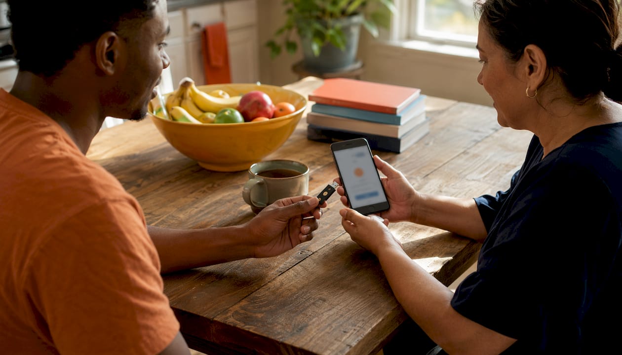 Hands holding security key and smartphone