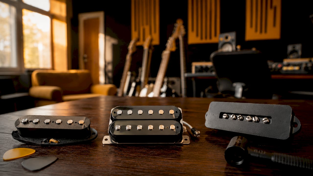 Various electric guitar pickup types on table