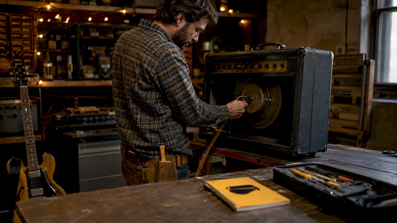 Technician checking impedance and power ratings