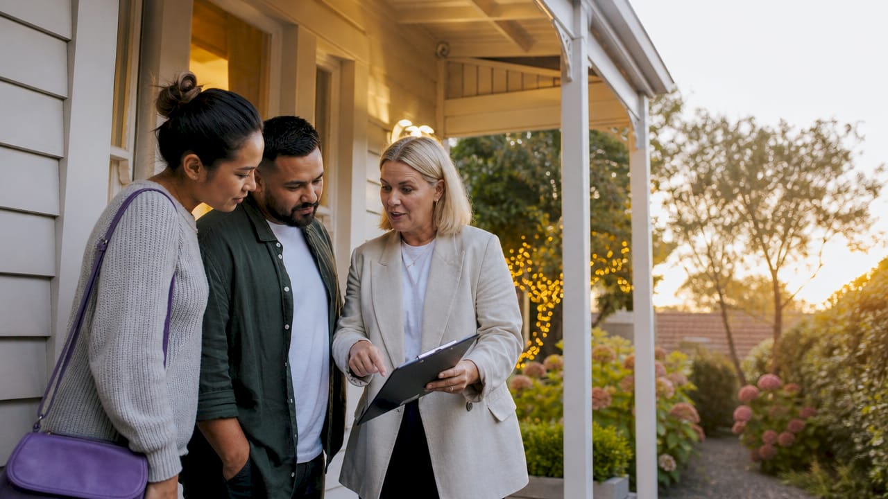 Agent explaining pre-auction benefits to couple