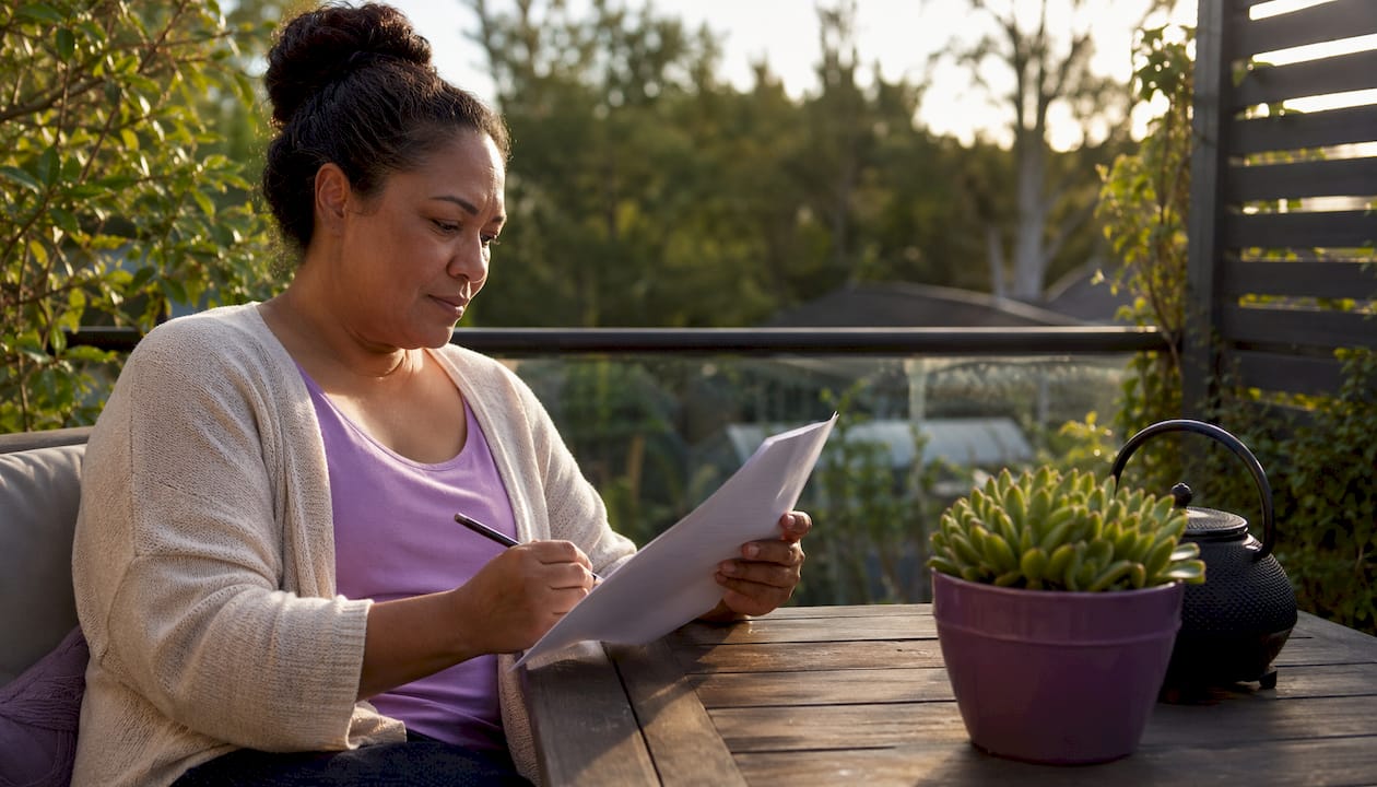 Hands reviewing home valuation report at kitchen table