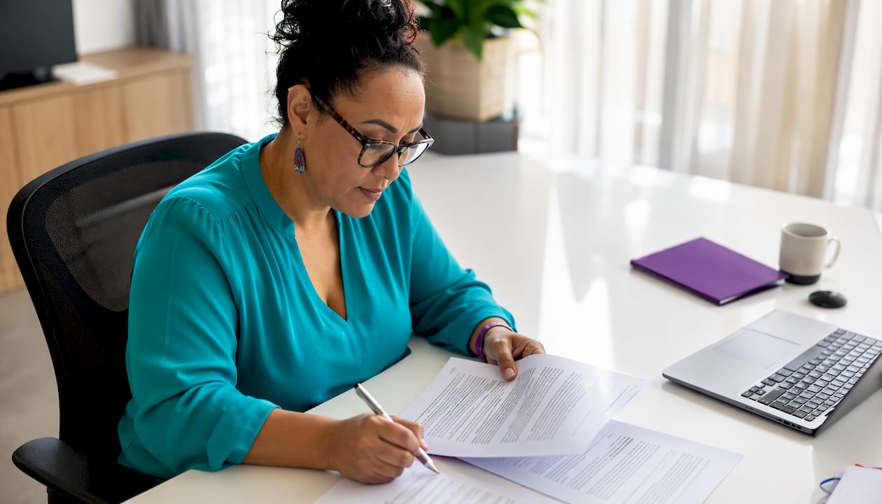Polynesian lawyer reviewing NZ sale documents