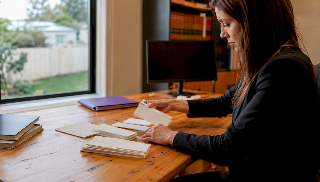 Hands placing deposit slip in lawyer office