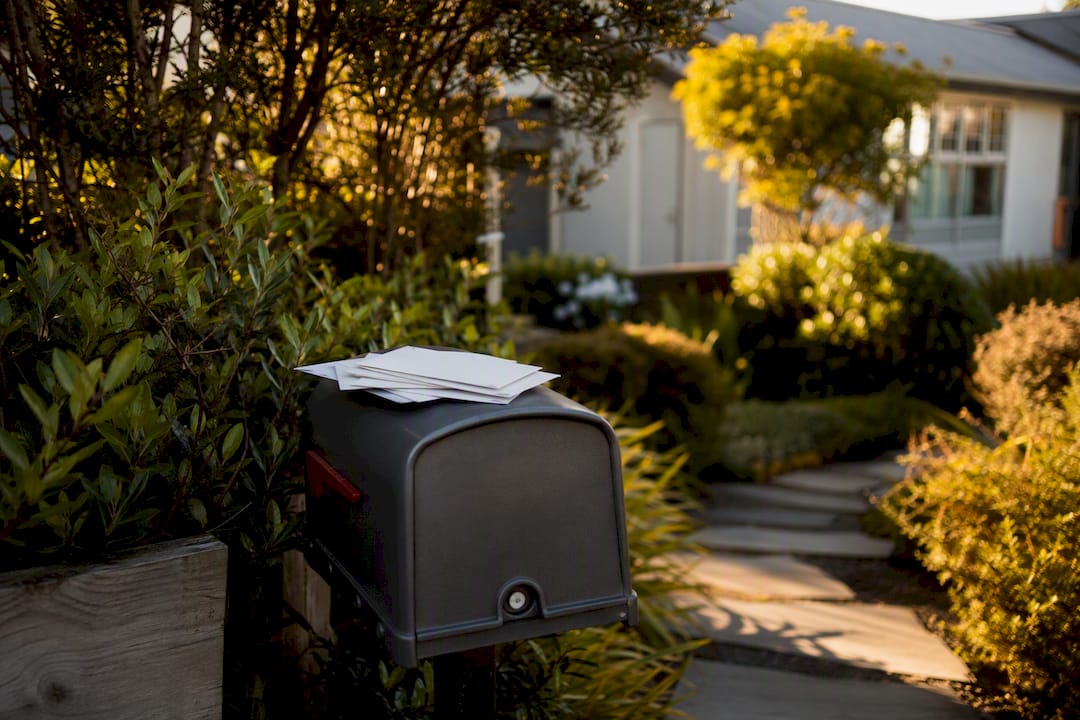 Mailbox with blank envelopes in NZ yard