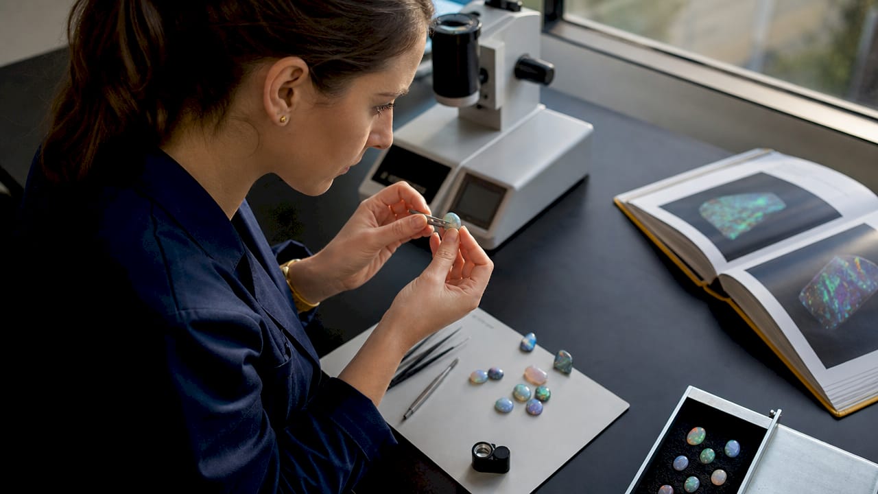 Gemologist inspecting opal in laboratory