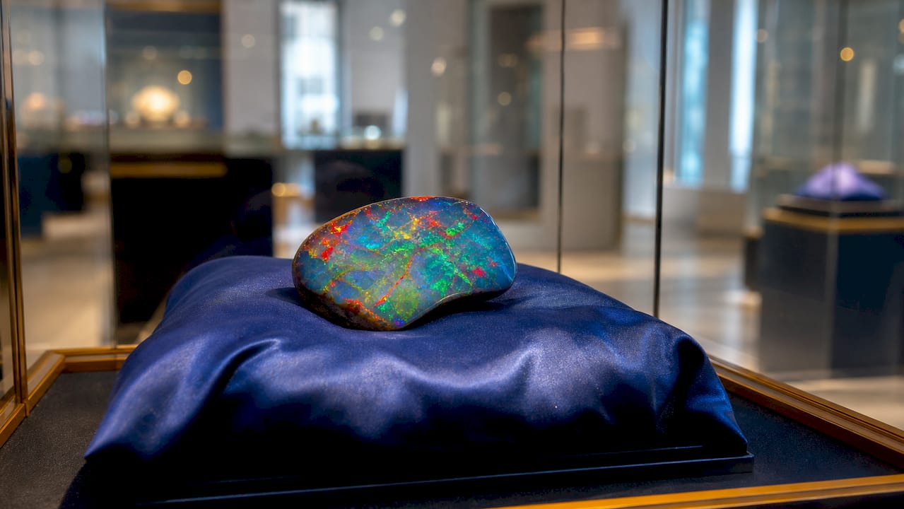 Olympic Australis opal gemstone in museum case