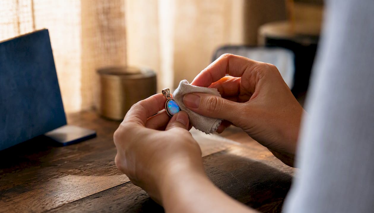 Hand wiping doublet opal gently with cloth