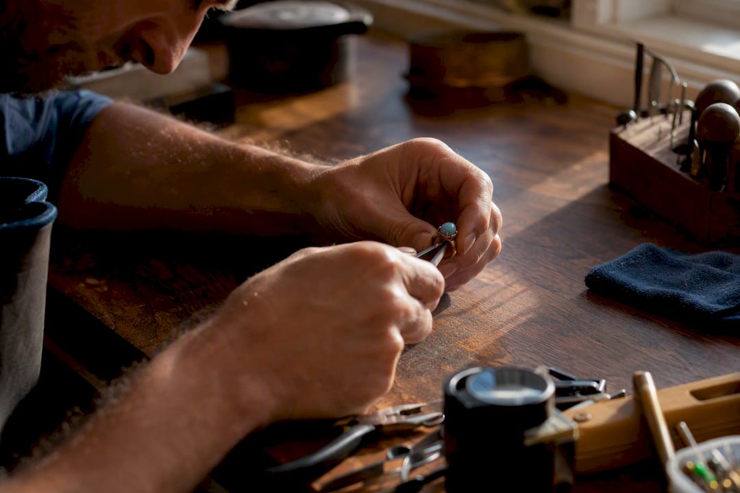 Jeweler setting boulder opal into ring