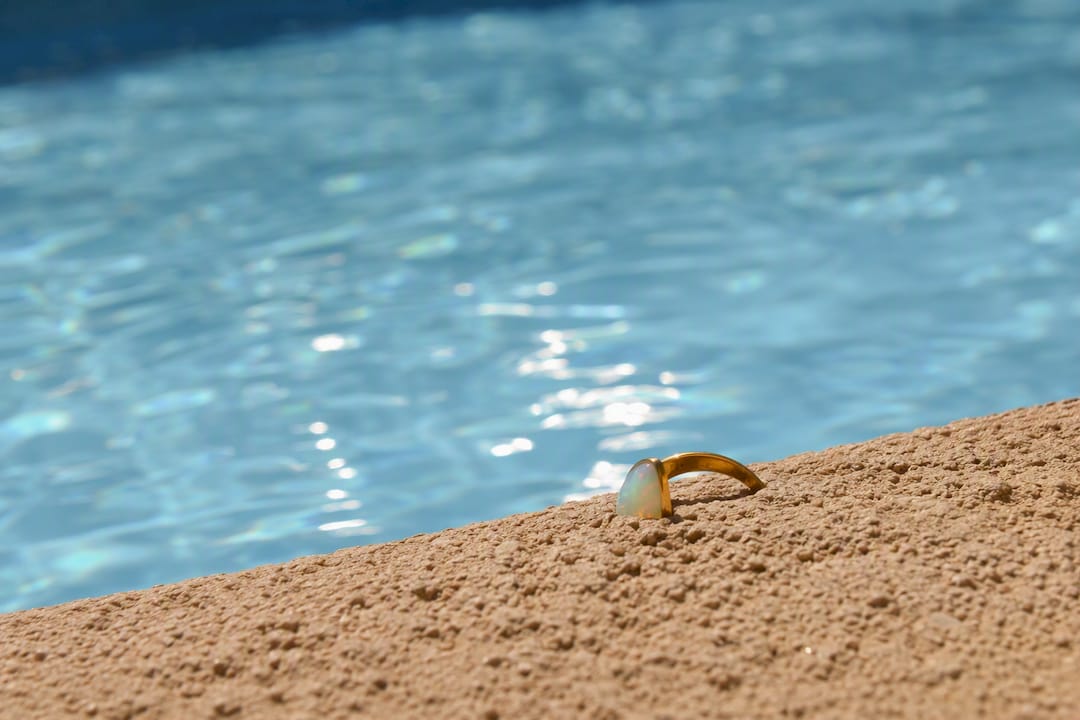Opal ring near swimming pool edge