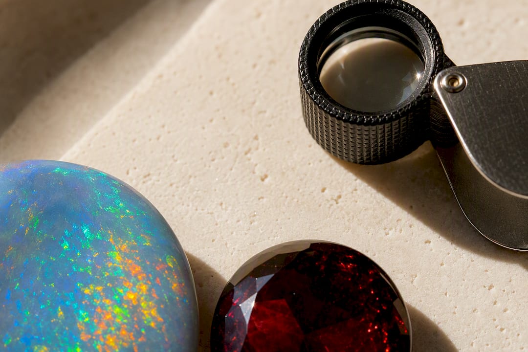 Opal play-of-color beside garnet in daylight