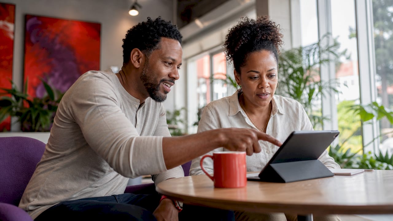 Two professionals discussing e-commerce BI dashboard
