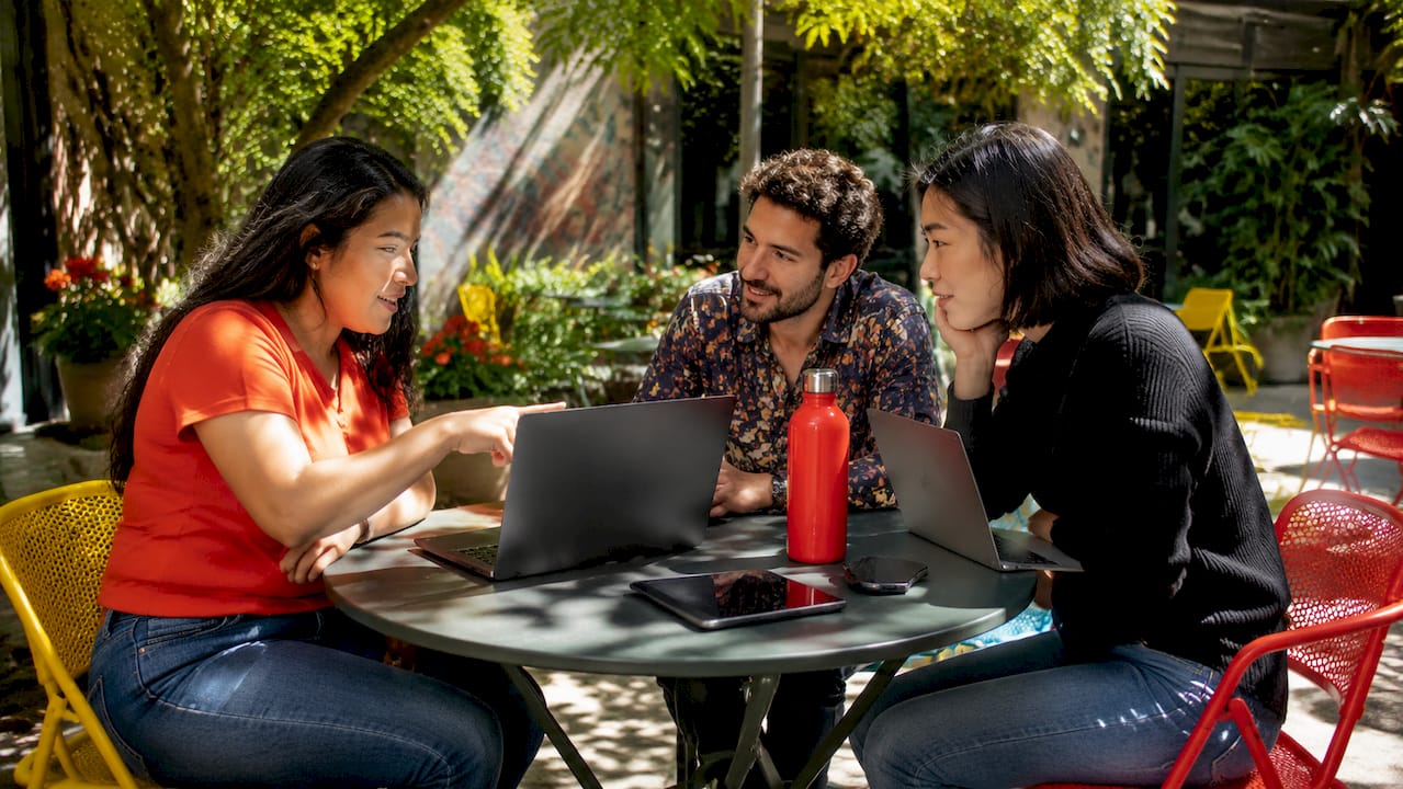 Two professionals collaborating on AI analytics tablet