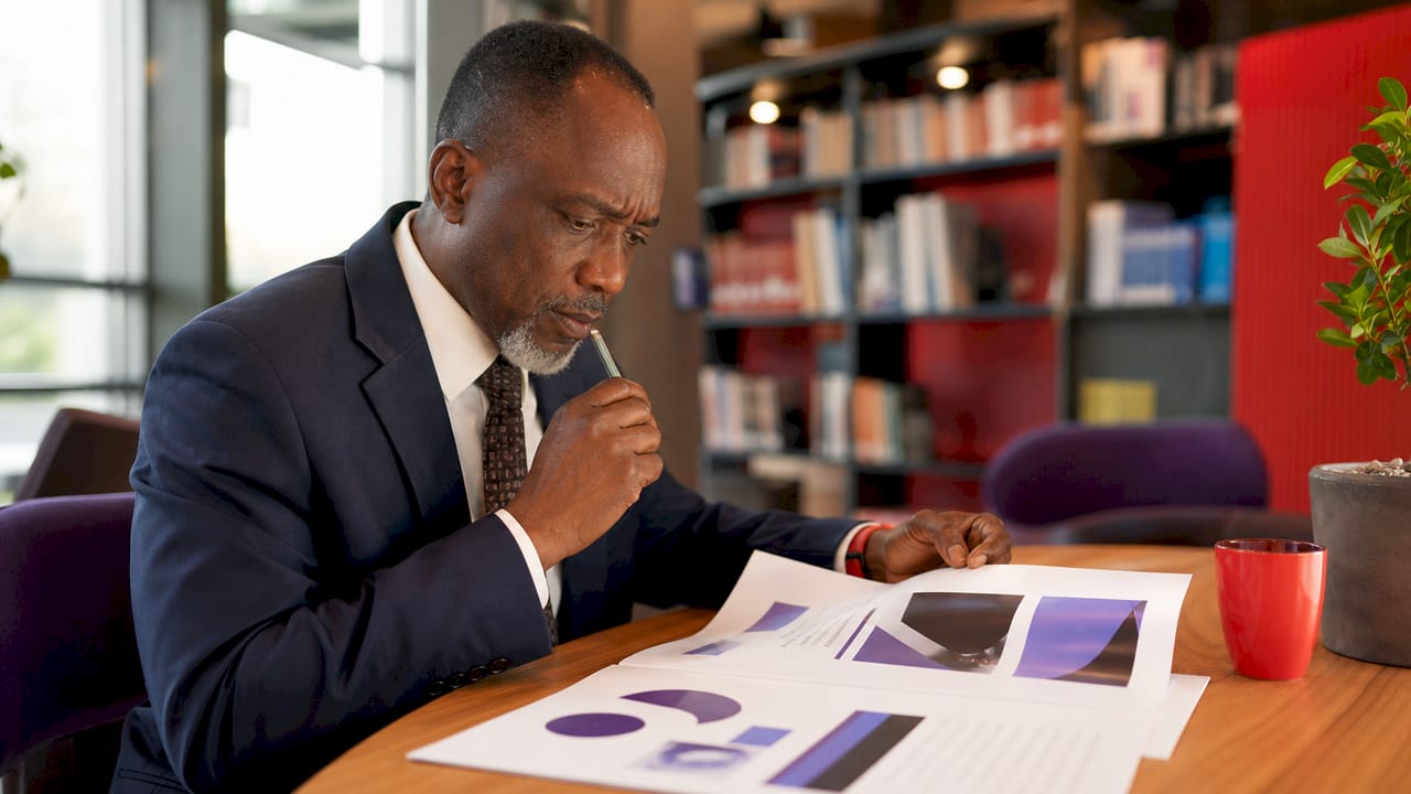 Man contemplating real-time dashboard in conference room
