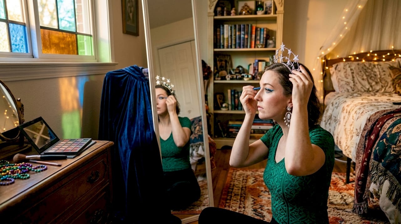Young adult woman applying Halloween makeup