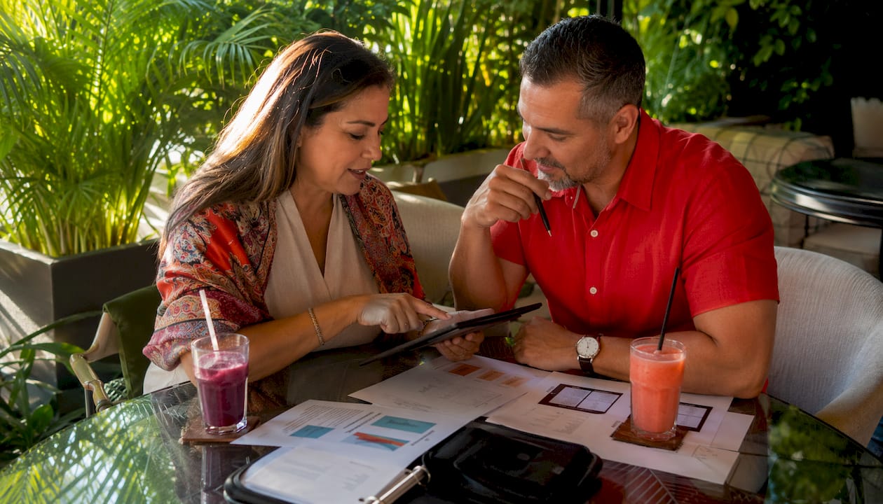 Couple planning social media strategy in café