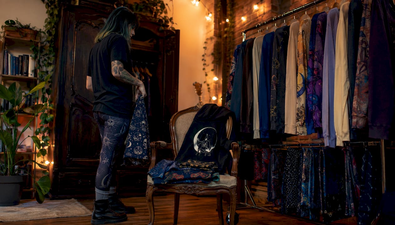 Person planning casual outfits in dressing room