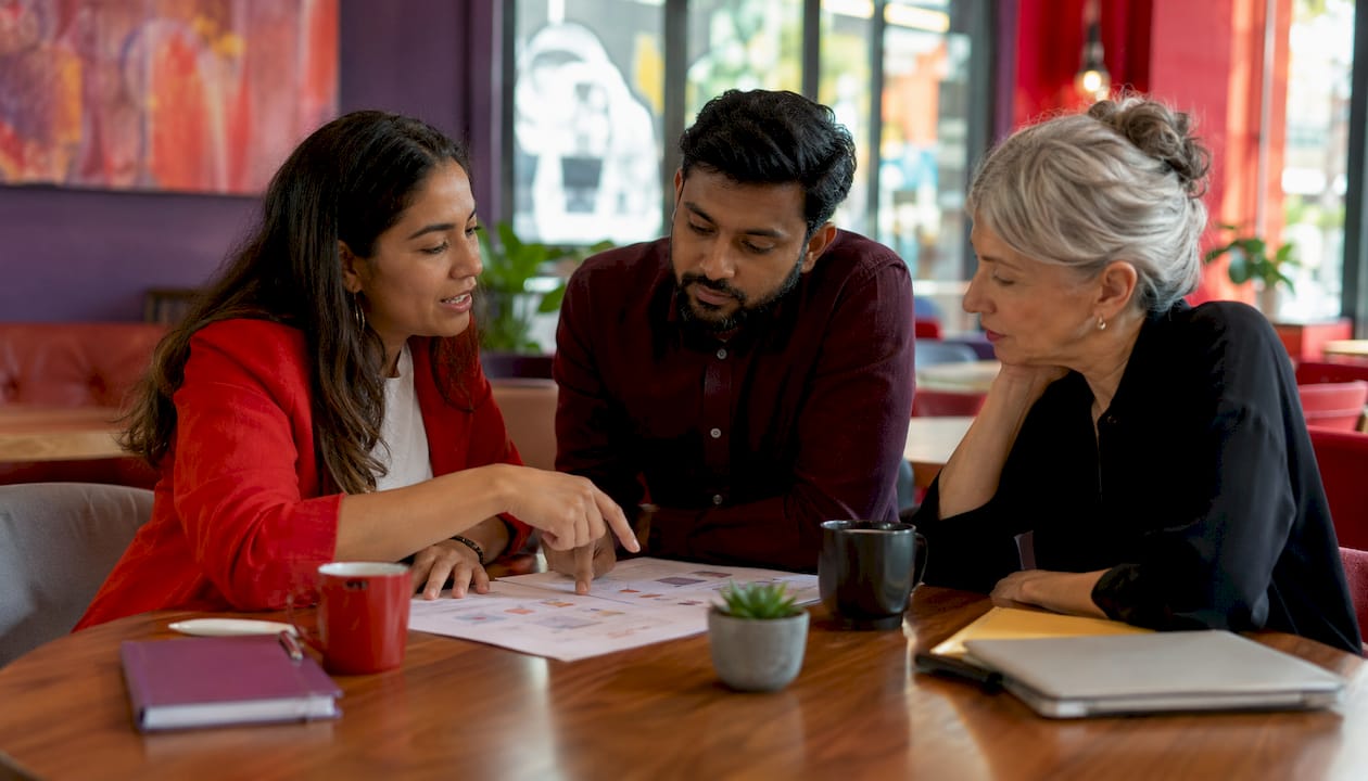 Team discussing hybrid strategy in modern office lounge