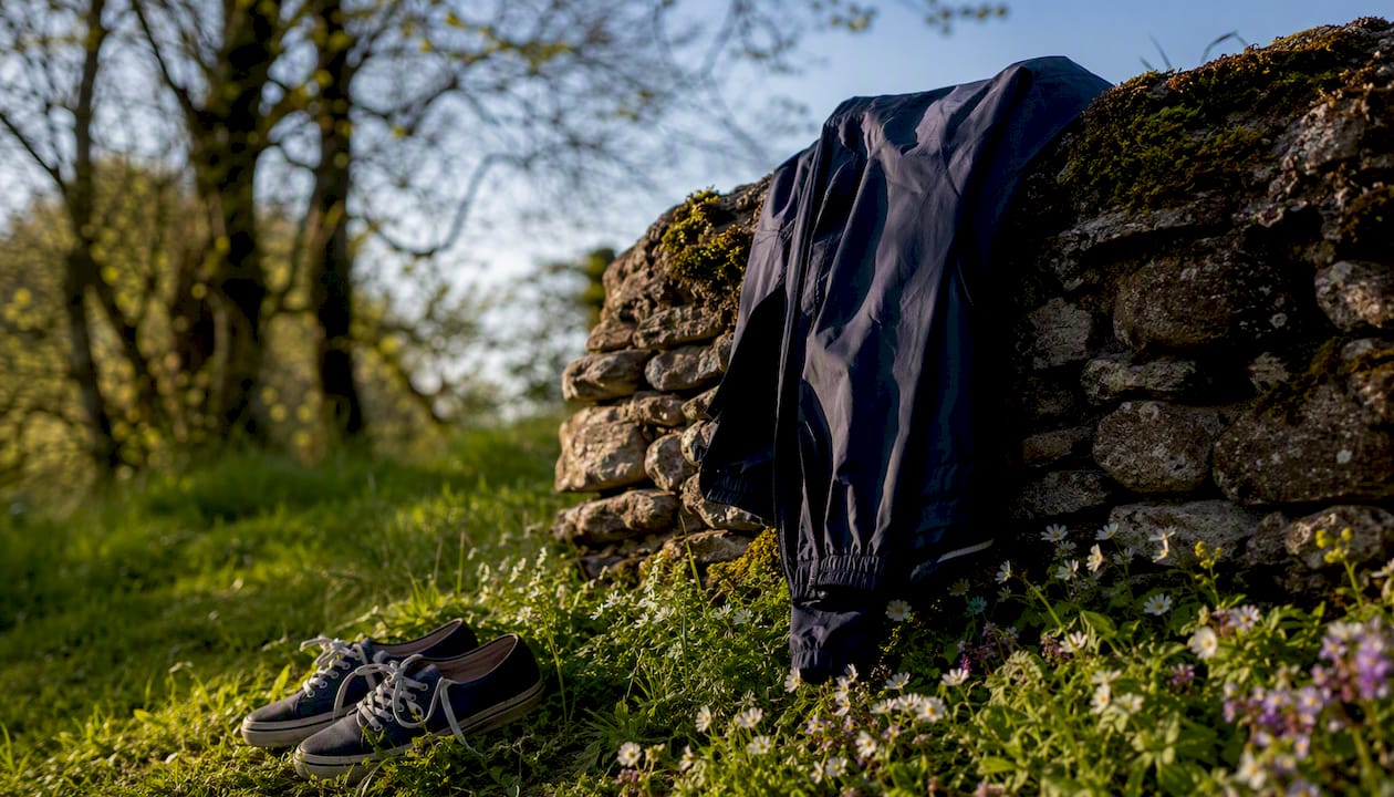 Midweight sweater and rain jacket on park bench