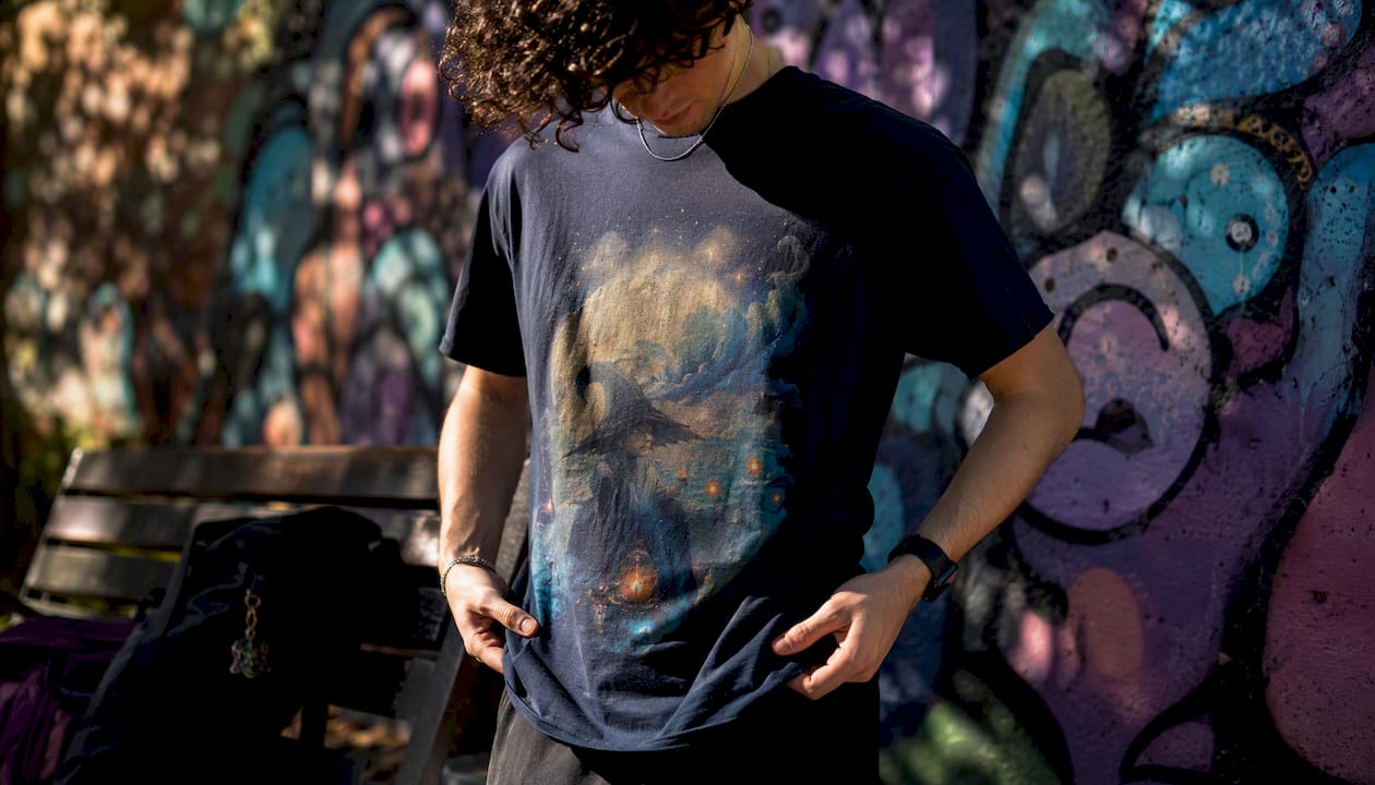 Young adult adjusting graphic tee outdoors