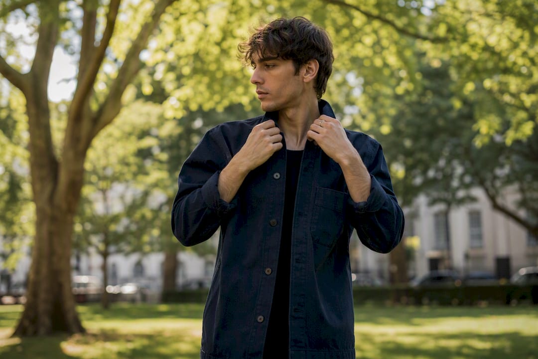 Person adjusting jacket sleeve confidently