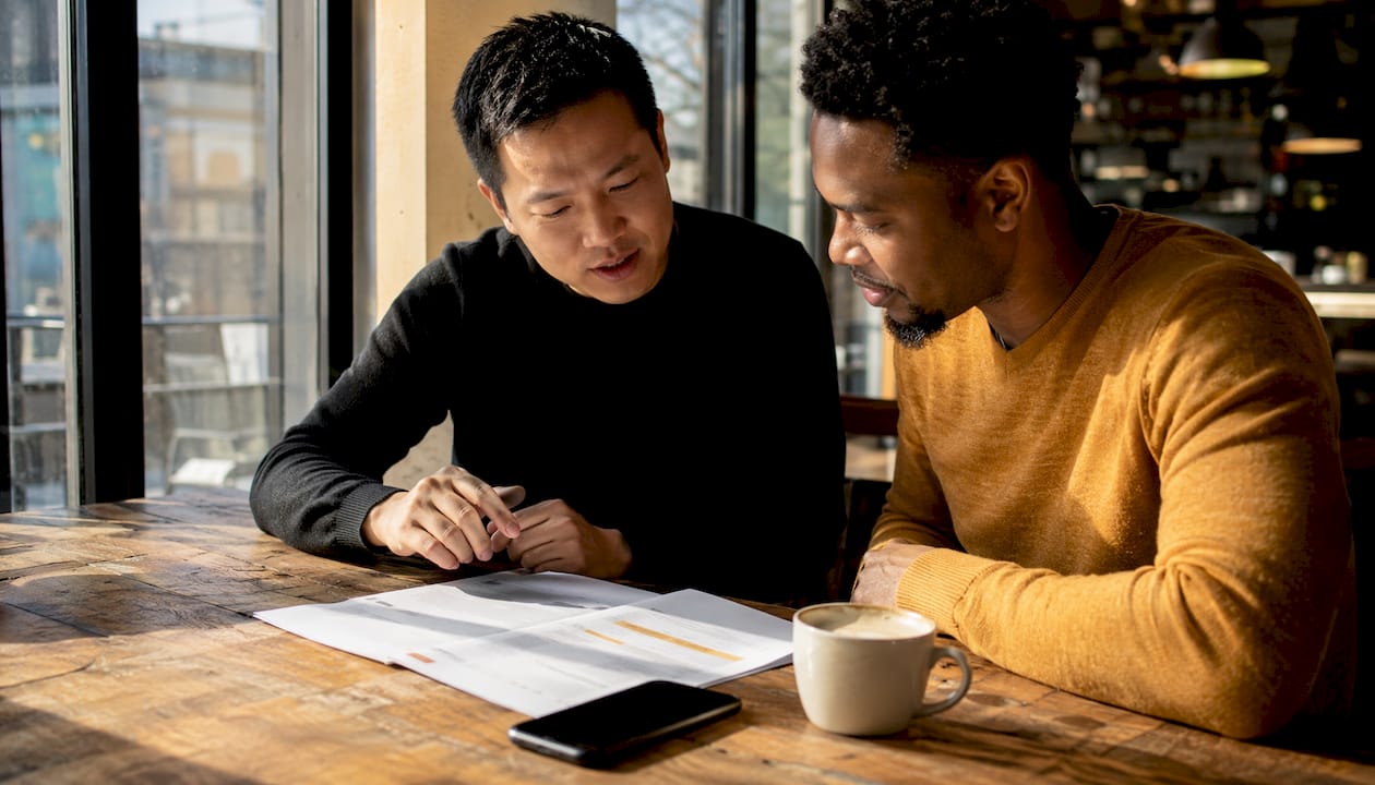 Two partners reviewing missed call text-back setup guide