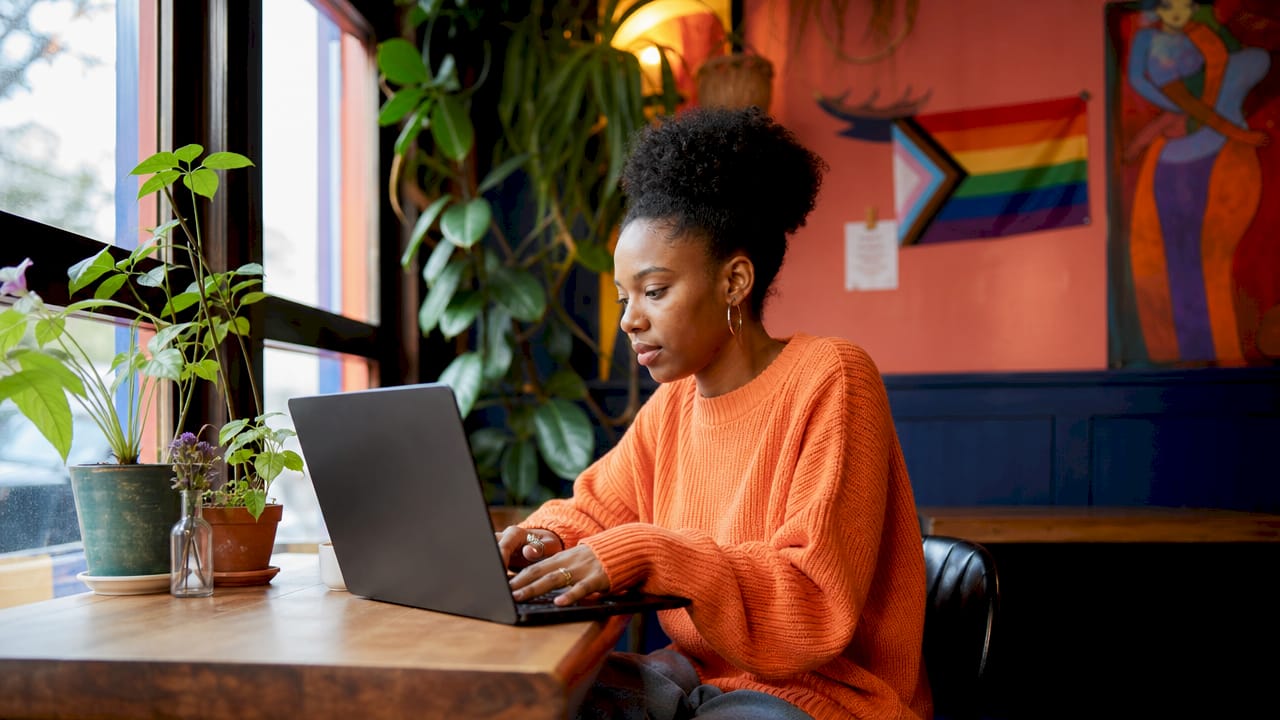 Young woman working in pride-supportive workspace