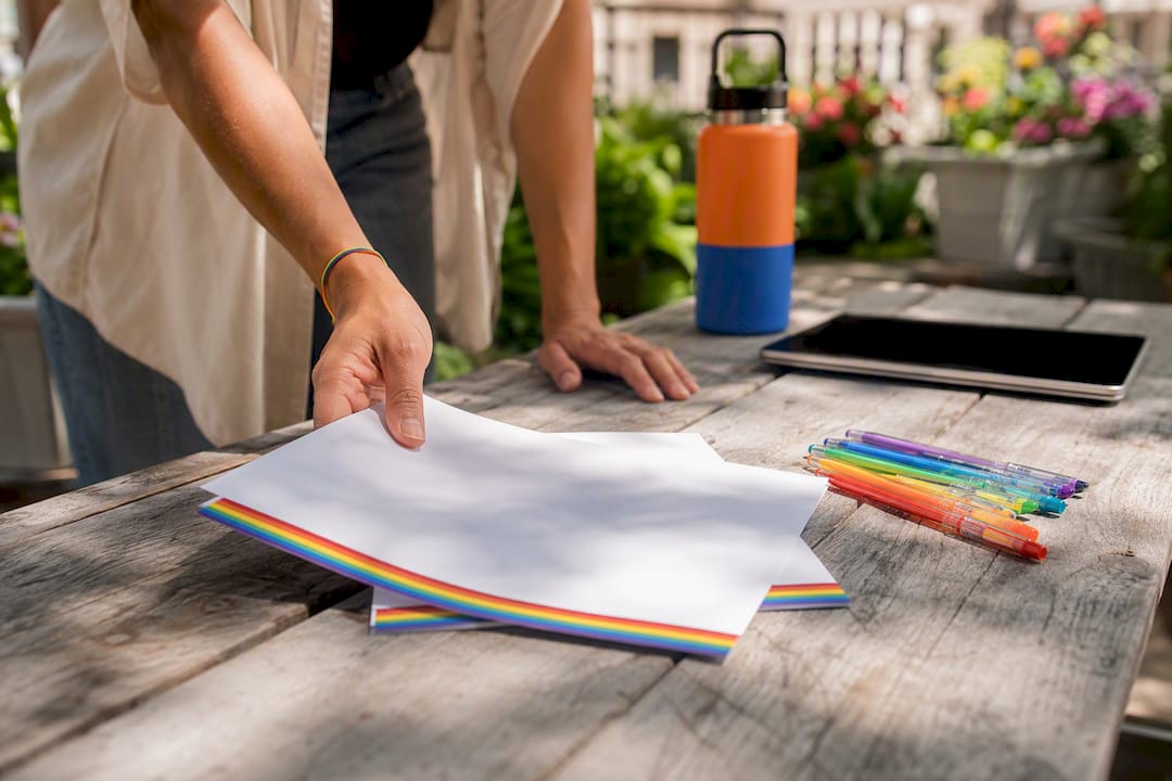Hand placing nondiscrimination policy on desk