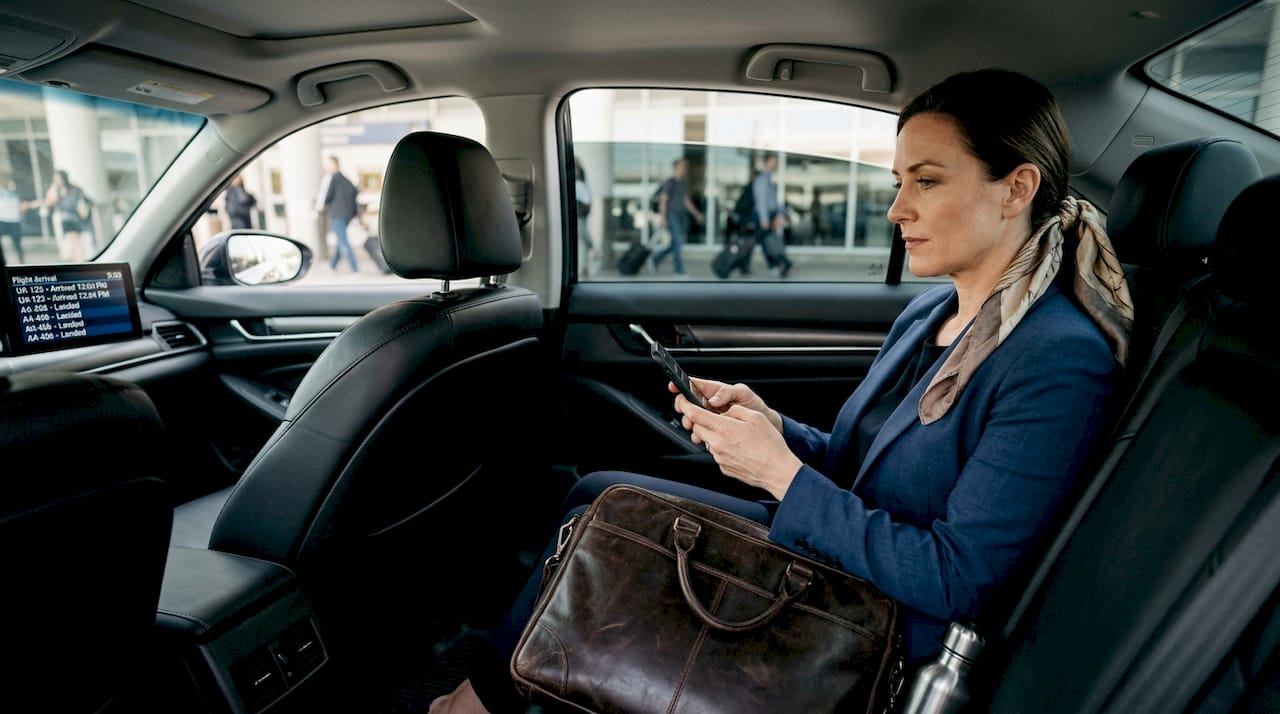 Businesswoman in chauffeured airport pickup