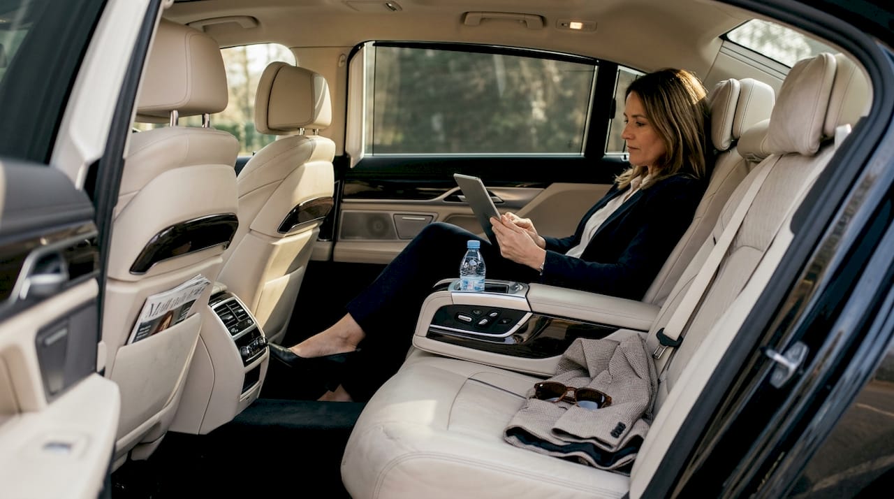 Executive relaxes in luxury car interior