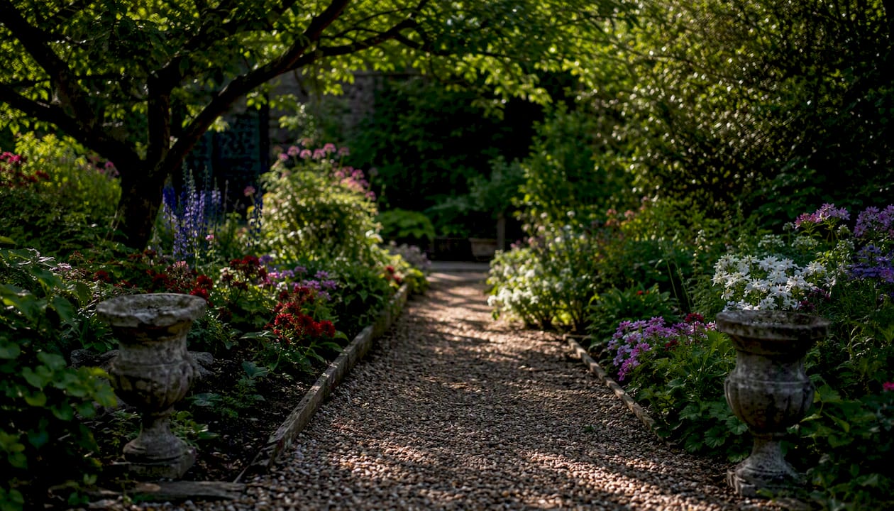 Gravel path with steel edging beside mulched beds